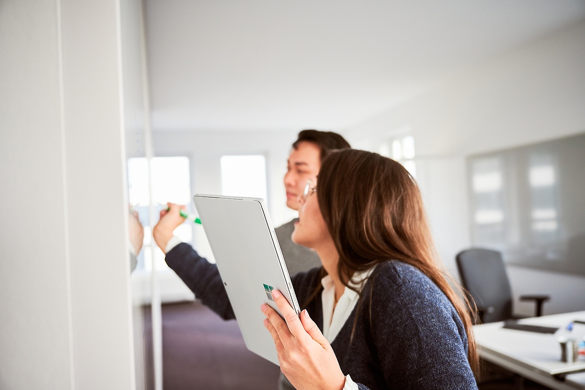 Employees working at a whiteboard