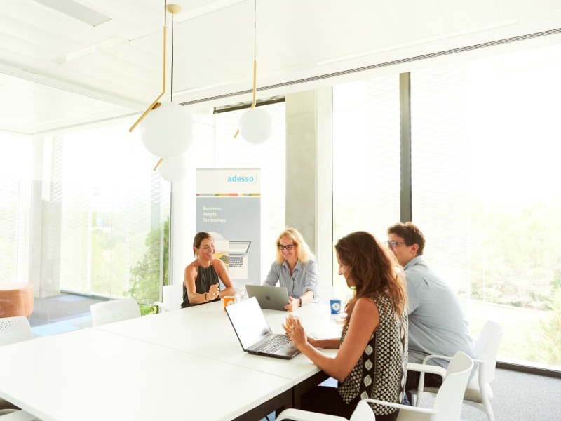 a group of people sits together at a conference table and talks