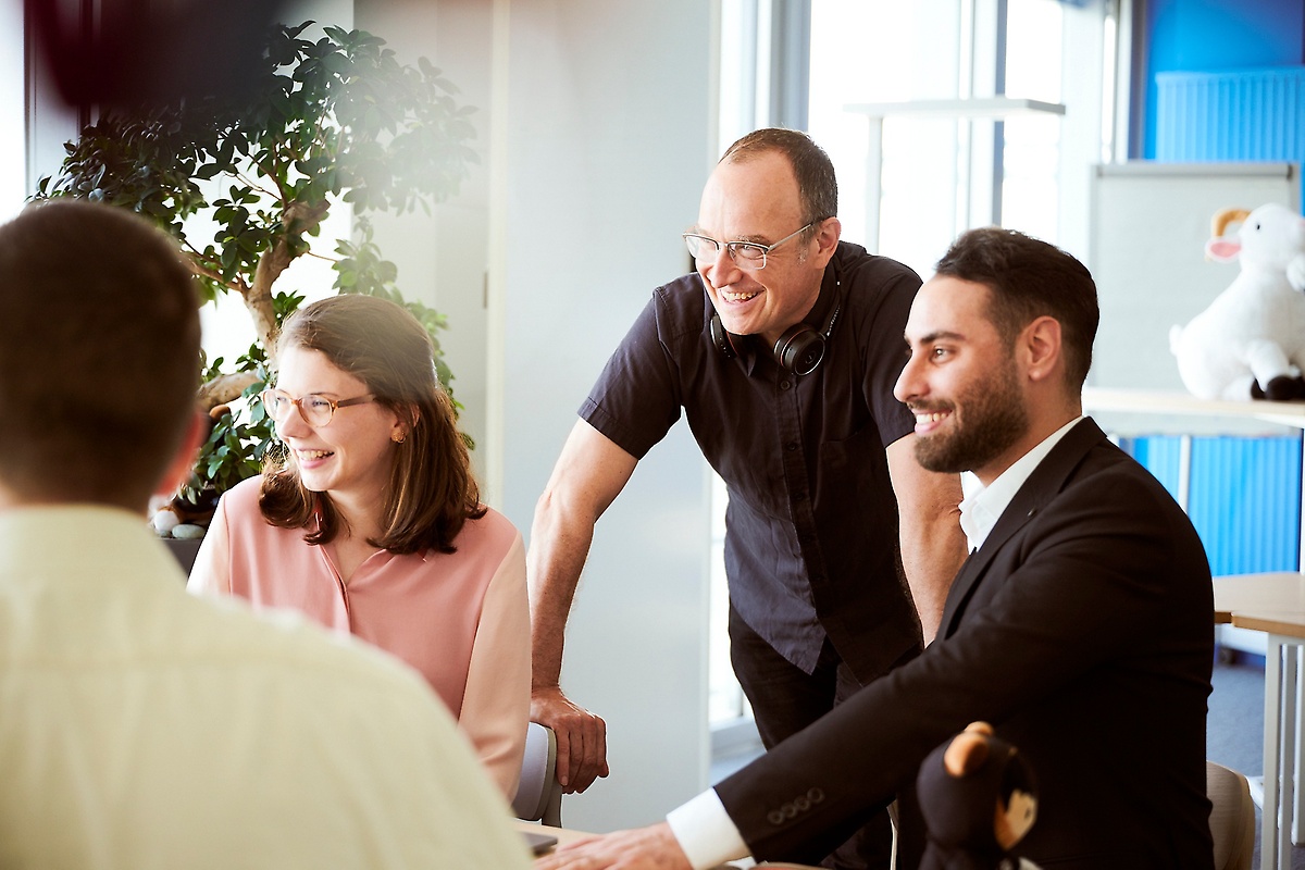 Employees in a conversation in the office Employees in a conversation in the office